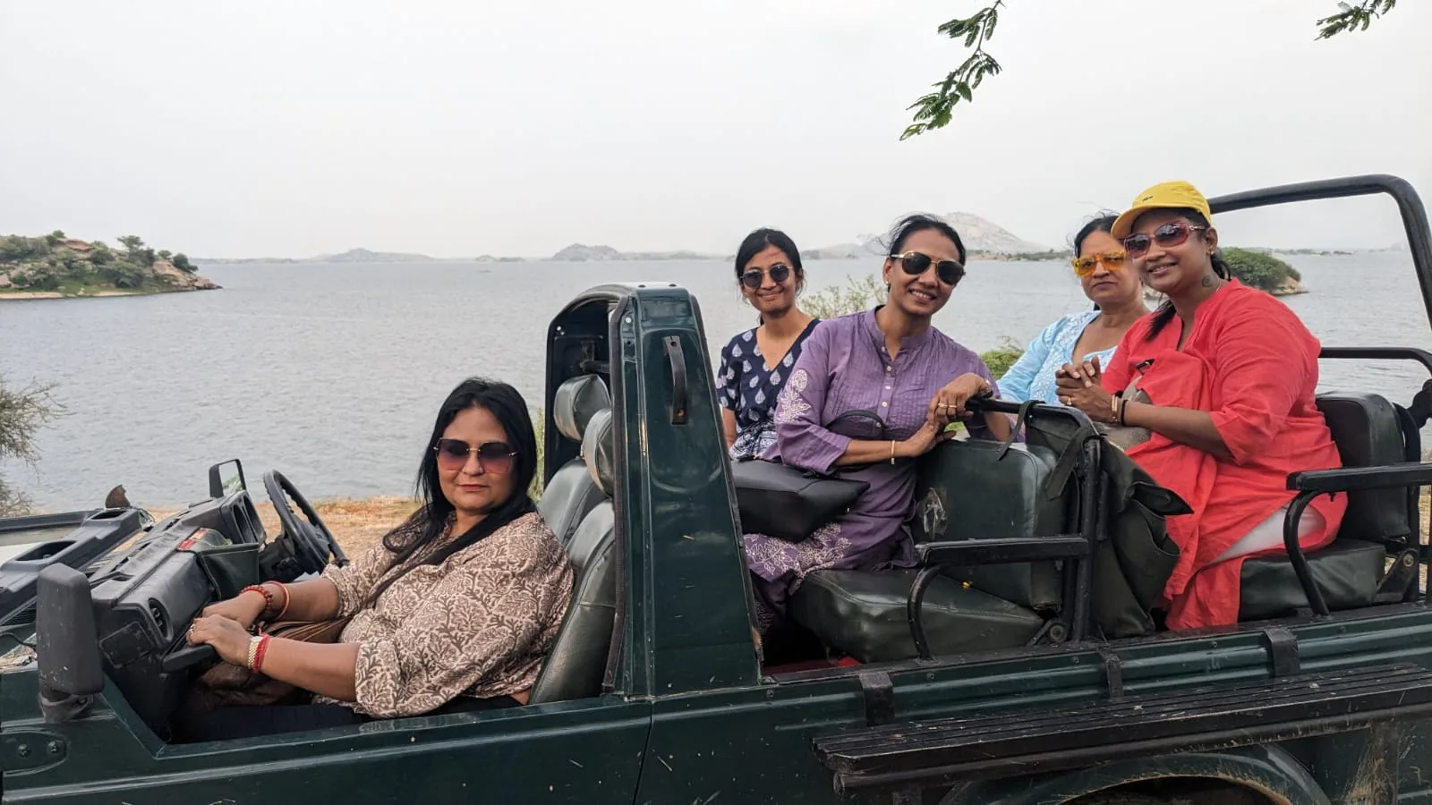 Visitors out on the lake drive in an open jeep